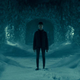 A girl stands in a snowy, blue-hued hedge maze in Doctor Sleep, the sequel to The Shining.